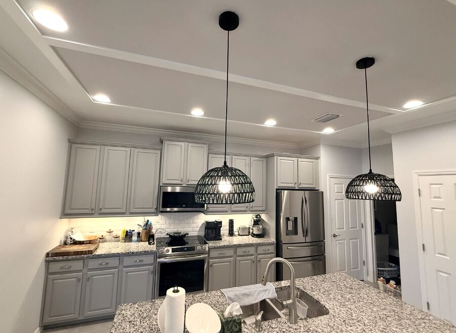 Kitchen with freshly painted light-gray cabinets and coffered ceiling