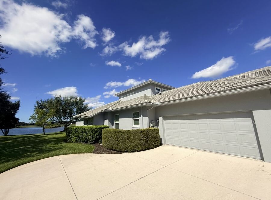 Light-gray exterior repaint on a lakeside Sarasota home