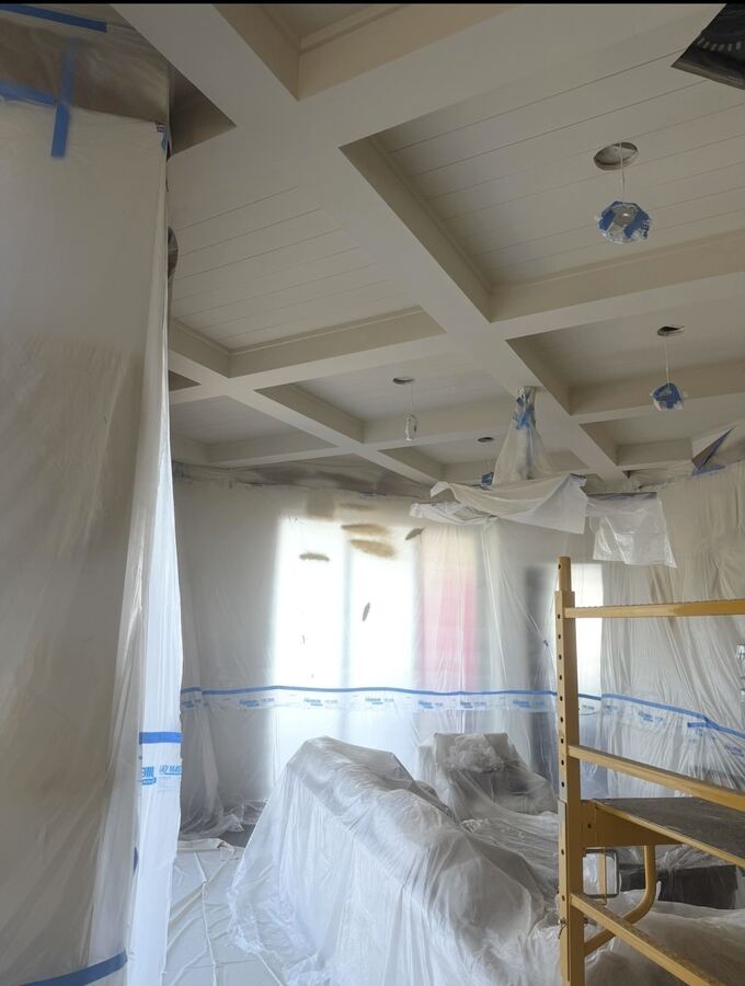 Living room fully masked for spray-finishing a coffered ceiling