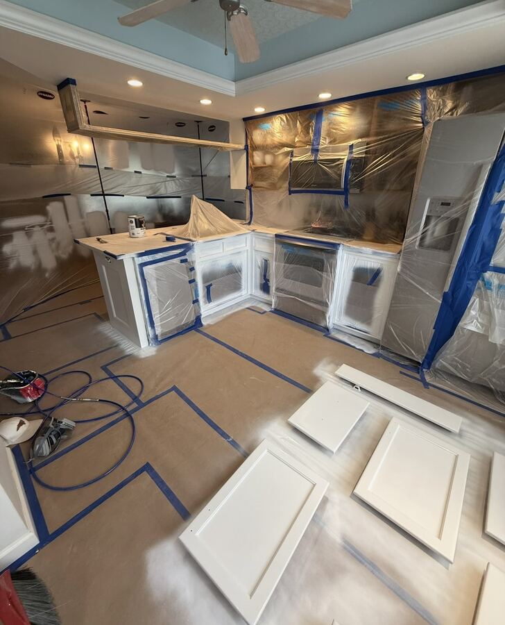 Cabinet doors primed and drying during a kitchen refinish