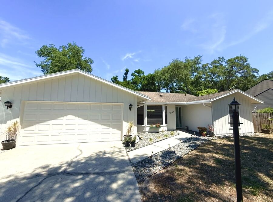 Fresh white exterior paint on a Florida ranch home with double garage