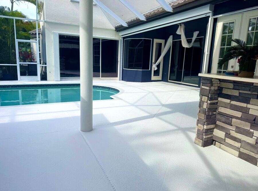 Freshly coated white pool deck with stone bar column
