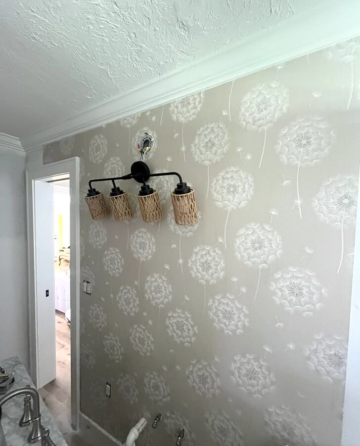 Dandelion feature wall beside a bathroom vanity light