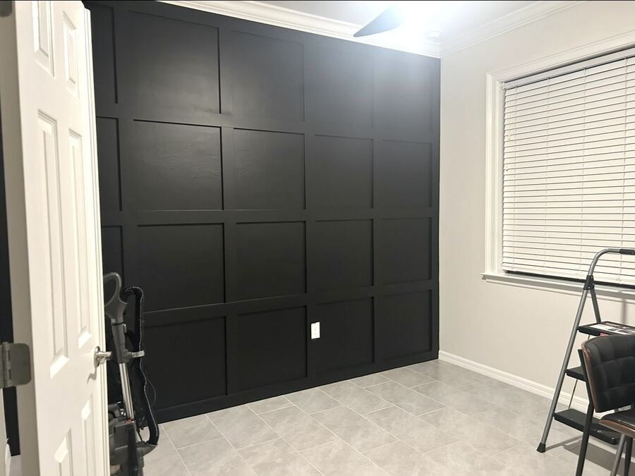 Matte black board-and-batten accent wall in a home office