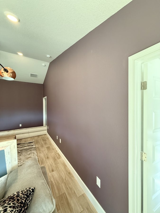 Aubergine accent wall in an upstairs loft hallway